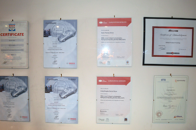 Framed certificates on the wall at KCS Autos