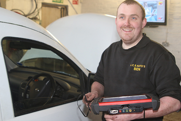 KCS mechanic holding a diagnostic tablet