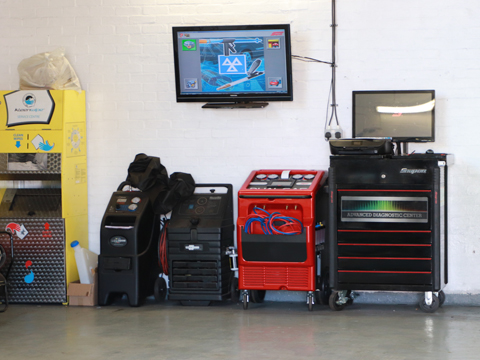 Diagnostic and air conditioning equipment lined up in the workshop