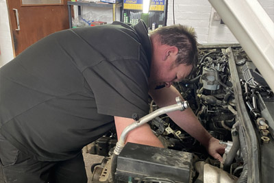 Mechanic working in an engine bay