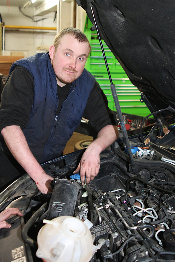 KCS mechanic working in an engine bay