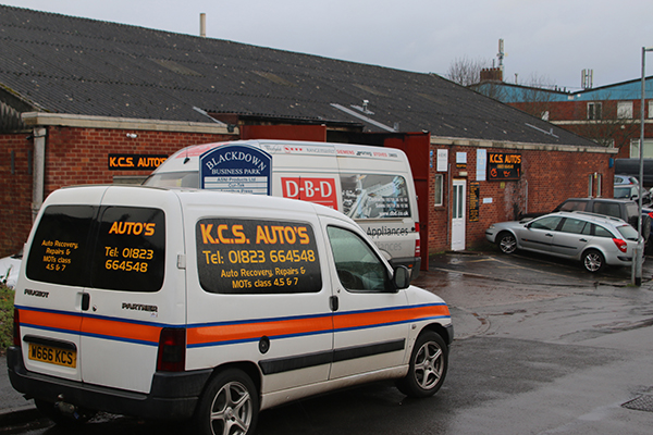 A K.C.S. Auto's van outside the unit