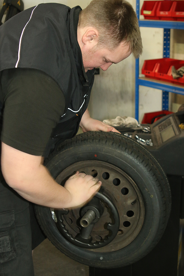 Mechanic fitting a wheel
