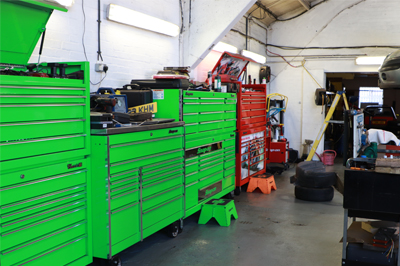 The workshop with its row of green tool chests
